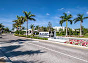 Thumbnail 63 of 78 - A street view of Blue Lake atlantic with palm trees and a clear blue sky.