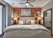 Thumbnail 18 of 25 - a bedroom with a large bed and a ceiling fan