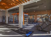 Thumbnail 13 of 40 - a gym with a lot of machines and weights in it