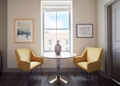 Thumbnail 5 of 25 - A room with a table and two chairs.