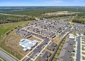Thumbnail 29 of 53 - an aerial view of a neighborhood of houses and a parking lot