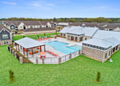 Thumbnail 32 of 53 - an aerial view of an outdoor pool with buildings in the background