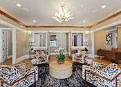 Thumbnail 34 of 53 - a living room with zebra print chairs and a table