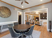 Thumbnail 35 of 53 - a dining room with a large clock on the wall and a dining table