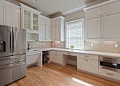 Thumbnail 37 of 53 - a kitchen with white cabinets and stainless steel appliances