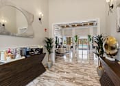 Thumbnail 5 of 53 - the lobby of a hotel with a reception desk and potted plants
