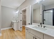Thumbnail 45 of 53 - a bathroom with a sink and a mirror and a shower