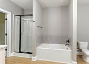 Thumbnail 47 of 53 - a bathroom with a tub and a shower and a toilet
