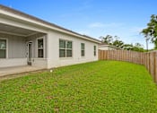 Thumbnail 49 of 53 - the backyard of a house with a green lawn and a wooden fence