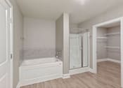 Thumbnail 21 of 53 - a bathroom with a tub and a shower and a closet