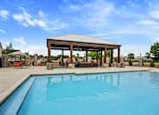 Thumbnail 24 of 36 - A pool with a pavilion over it.