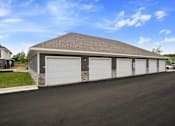 Thumbnail 29 of 36 - A two-car garage with a stone pillar on the left side.