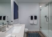 Thumbnail 23 of 78 - a bathroom with a shower and a sink and a toilet at Altis Blue Lake, Lake Worth, FL, 33467