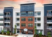 Thumbnail 1 of 25 - an exterior view of an apartment building with a red brick facade
