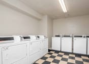 Thumbnail 13 of 23 - A row of washing machines in a laundromat.