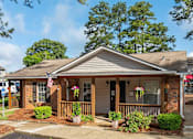 Thumbnail 17 of 23 - A house with a flag on the porch.