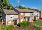 Thumbnail 21 of 23 - A row of houses with a clear blue sky above them.