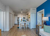 Thumbnail 18 of 35 - A modern kitchen with a dining table and chairs.
