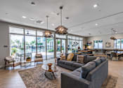 Thumbnail 10 of 35 - A spacious living room with a grey sofa and a large window.
