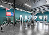 Thumbnail 5 of 35 - A gym with a variety of equipment and a sign that says "Stream Away To Become".