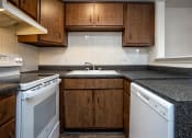 Thumbnail 9 of 16 - a kitchen with white appliances and brown cabinets