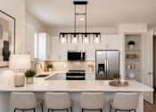 Thumbnail 27 of 40 - A modern kitchen with a large island and four chairs.