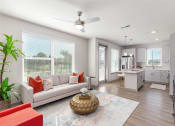 Thumbnail 6 of 23 - Dog-Friendly Apartments In Daytona Beach, FL - Madison Pointe - Open Living Room With Furniture, Area Rug, Ceiling Fan, Lots Of Windows, And View Of Kitchen.