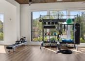 Thumbnail 15 of 49 - a home gym with ample windows and wood flooring