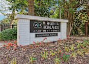 Thumbnail 28 of 28 - A sign for Virginia Highlands Apartment Homes stands in front of a tree.