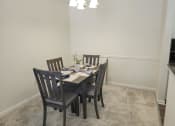 Thumbnail 25 of 39 - a dining room with a table and chairs
