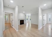 Thumbnail 53 of 59 - a renovated living room with a fireplace and wooden floors