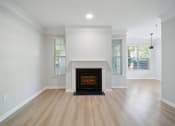 Thumbnail 52 of 59 - a living room with a fireplace and wooden floors