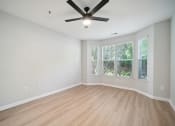 Thumbnail 56 of 59 - an empty living room with a ceiling fan and a window