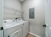 Thumbnail 46 of 59 - a washer and dryer in a laundry room with a door