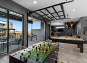 Thumbnail 31 of 94 - a game room with a foosball table and a pool table