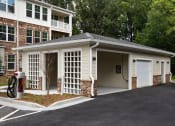 Thumbnail 39 of 46 - a garage with a white door and a white garage door on the side of a building
