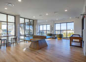 Thumbnail 5 of 40 - a living room with a ping pong table in the center of it