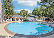 Thumbnail 1 of 28 - Atlanta, GA, Apartments Near Ponce City Market - Virginia Highlands - Swimming Pool with Spacious Sundeck, Lounge Chairs, Cabanas, and Trees.
