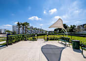 Thumbnail 60 of 78 - A park with a bench and a shade structure.