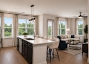 Thumbnail 34 of 40 - A modern kitchen with a large island and a dining area with a view.
