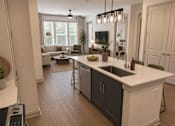 Thumbnail 38 of 40 - A modern kitchen with a large island and a dining area.