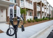 Thumbnail 37 of 46 - a pair of electric car chargers sit in front of an apartment building