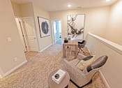 Thumbnail 36 of 71 - a living room with a chair and table
