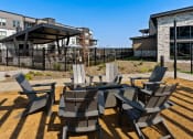 Thumbnail 51 of 94 - a patio with chairs and tables and a building in the background