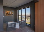 Thumbnail 11 of 40 - a living room with two chairs and a view of the city