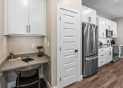 Thumbnail 73 of 94 - a kitchen with white cabinets and stainless steel appliances and a counter top with a refrigerator