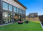 Thumbnail 52 of 94 - a yard with lawn bikes and a building with large windows