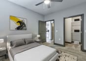 Thumbnail 16 of 25 - a bedroom with a white bed and a ceiling fan
