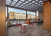 Thumbnail 20 of 40 - a rendering of a balcony with red chairs and tables
