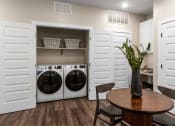 Thumbnail 88 of 94 - a washer and dryer in a laundry room with a table and chairs